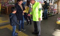 安全運転を促す相模原交通安全協会会員（右）