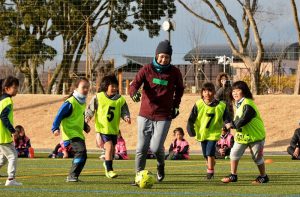 子供たちとボールを追いかける永里選手